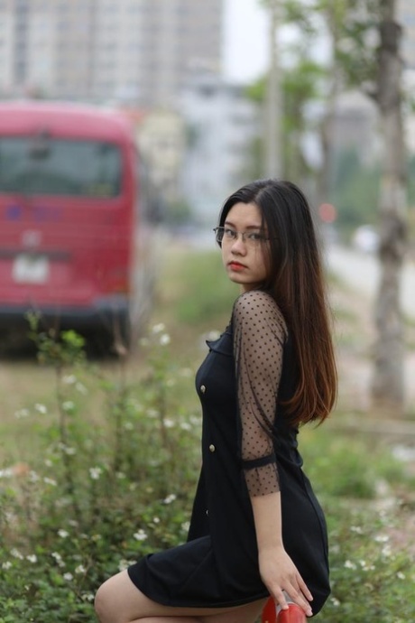Pretty Asian model Natalia posing in her lovely black outfit outdoors