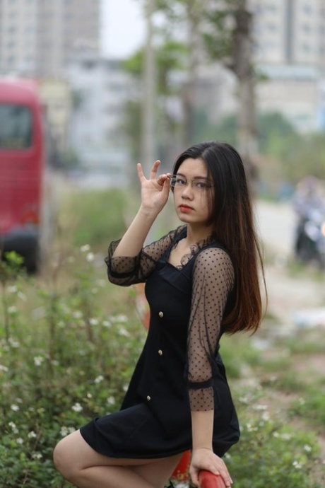 Pretty Asian model Natalia posing in her lovely black outfit outdoors