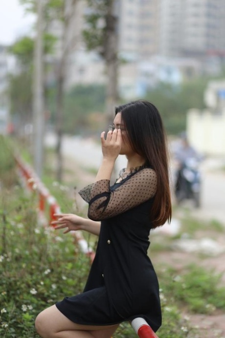Pretty Asian model Natalia posing in her lovely black outfit outdoors