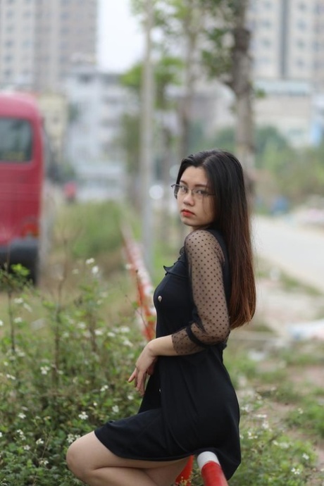 Pretty Asian model Natalia posing in her lovely black outfit outdoors
