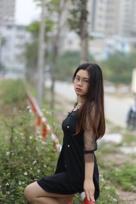 Pretty Asian model Natalia posing in her lovely black outfit outdoors