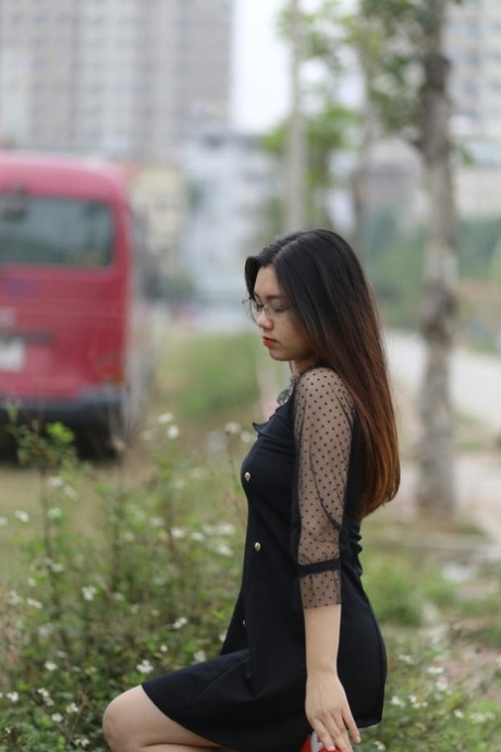 Pretty Asian model Natalia posing in her lovely black outfit outdoors