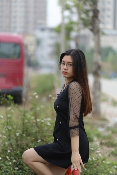 Pretty Asian model Natalia posing in her lovely black outfit outdoors