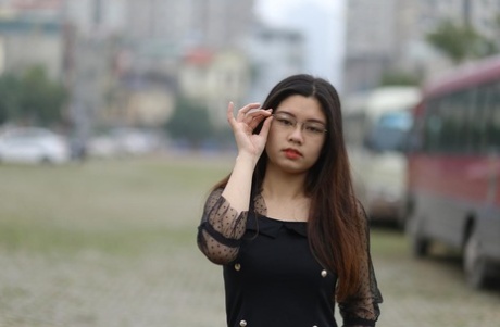 Pretty Asian model Natalia posing in her lovely black outfit outdoors