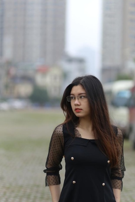 Pretty Asian model Natalia posing in her lovely black outfit outdoors