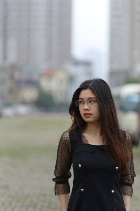 Pretty Asian model Natalia posing in her lovely black outfit outdoors