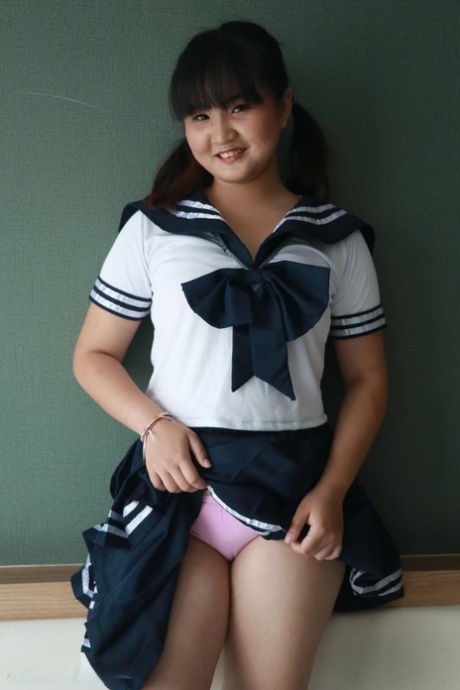 Naughty Asian schoolgirl shows her lovely teen tits & her big booty