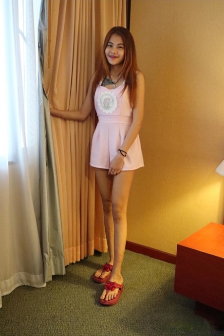 Asian babe unveils her trimmed pussy in a sexy striptease in her hotel room