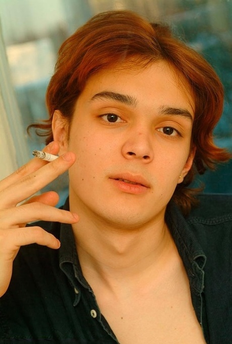 Good-looking twink unveils his small dick in a hot striptease after smoking