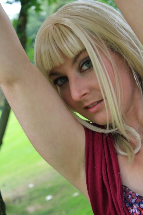 Blonde babe unveils her small breasts in a sexy bedroom striptease
