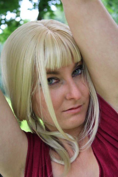 Blonde babe unveils her small breasts in a sexy bedroom striptease