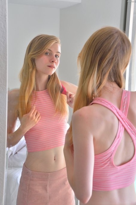 Slender girl Sharlotte stuffs her pussy with her fingers and a toy in a solo
